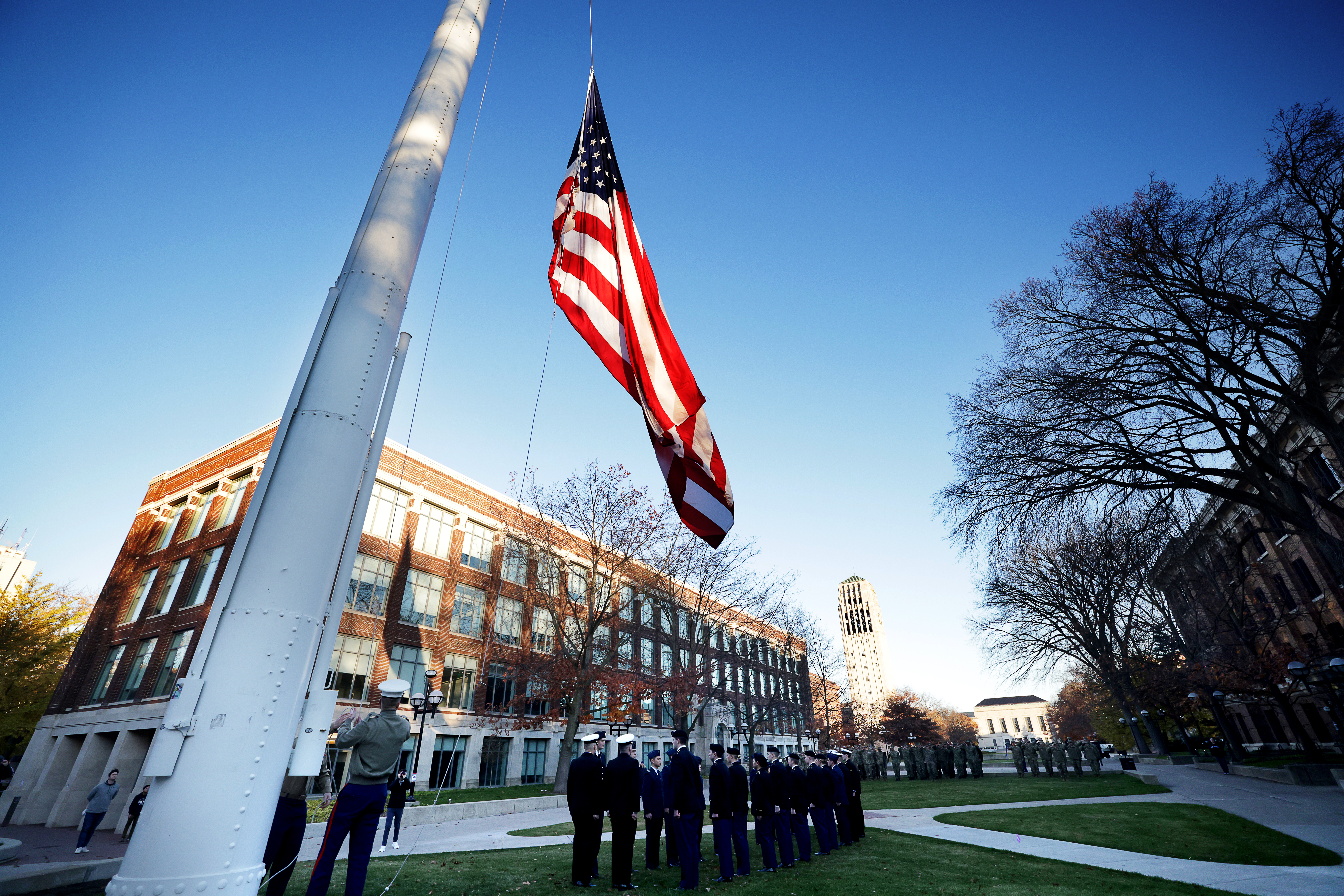 ROTC students raise American flag on flagphole
