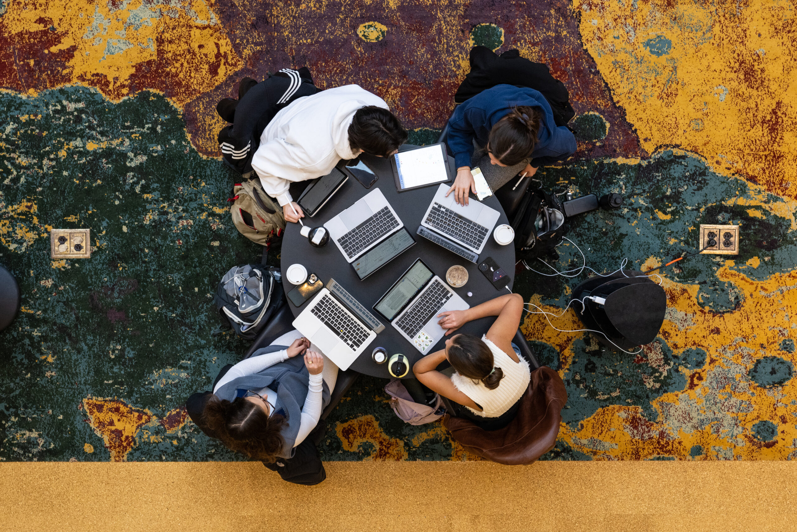 Aerial view of a group of students studying at a circular table