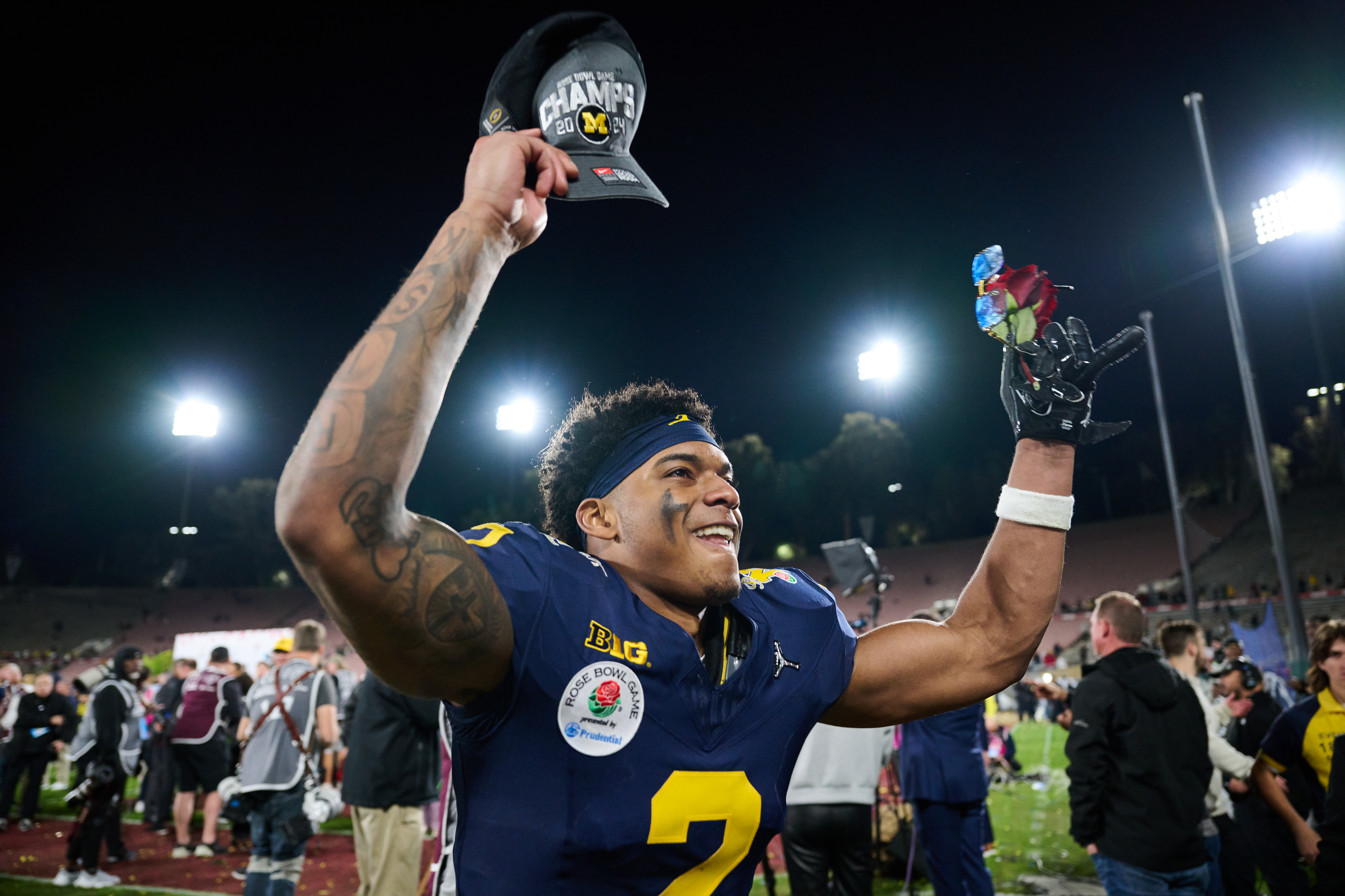 Michigan football player celebrates on field after winning Rose Bowl