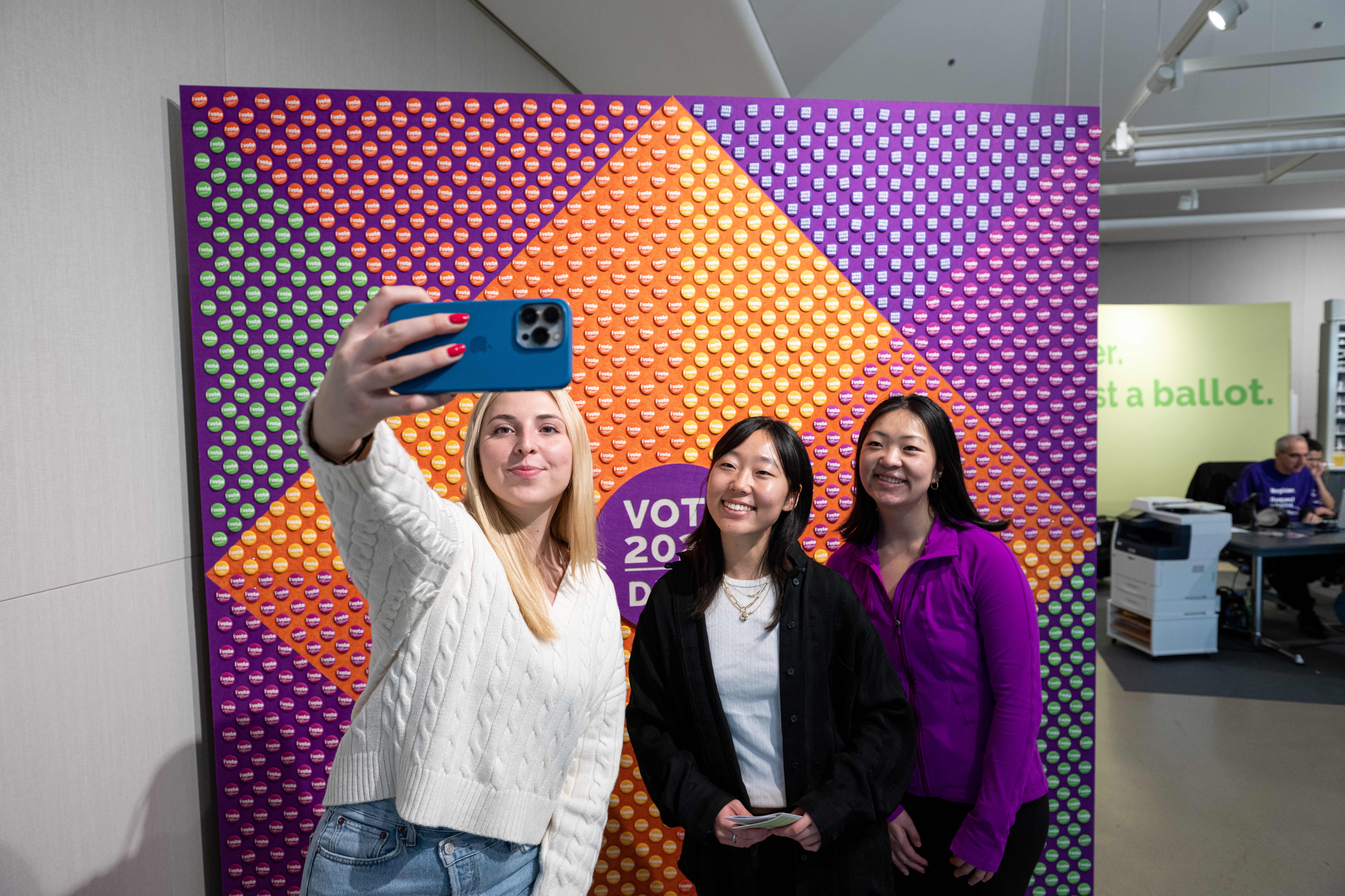 Students take a selfie at a voting promotion event