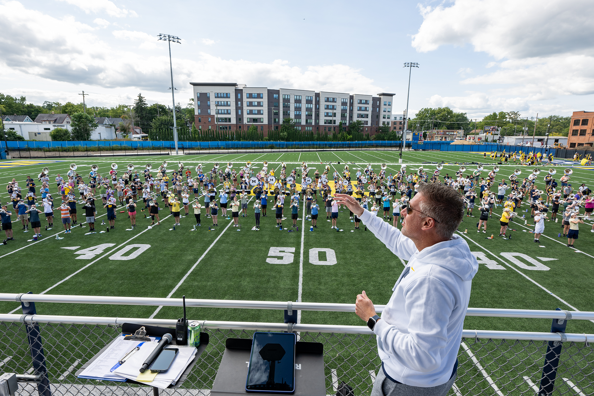 John Pasquale, Donald R. Shepherd Professor of Conducting and director of Michigan Marching and Athletic Bands, leads the band in a rehearsal at its new Elbel Field practice facility.