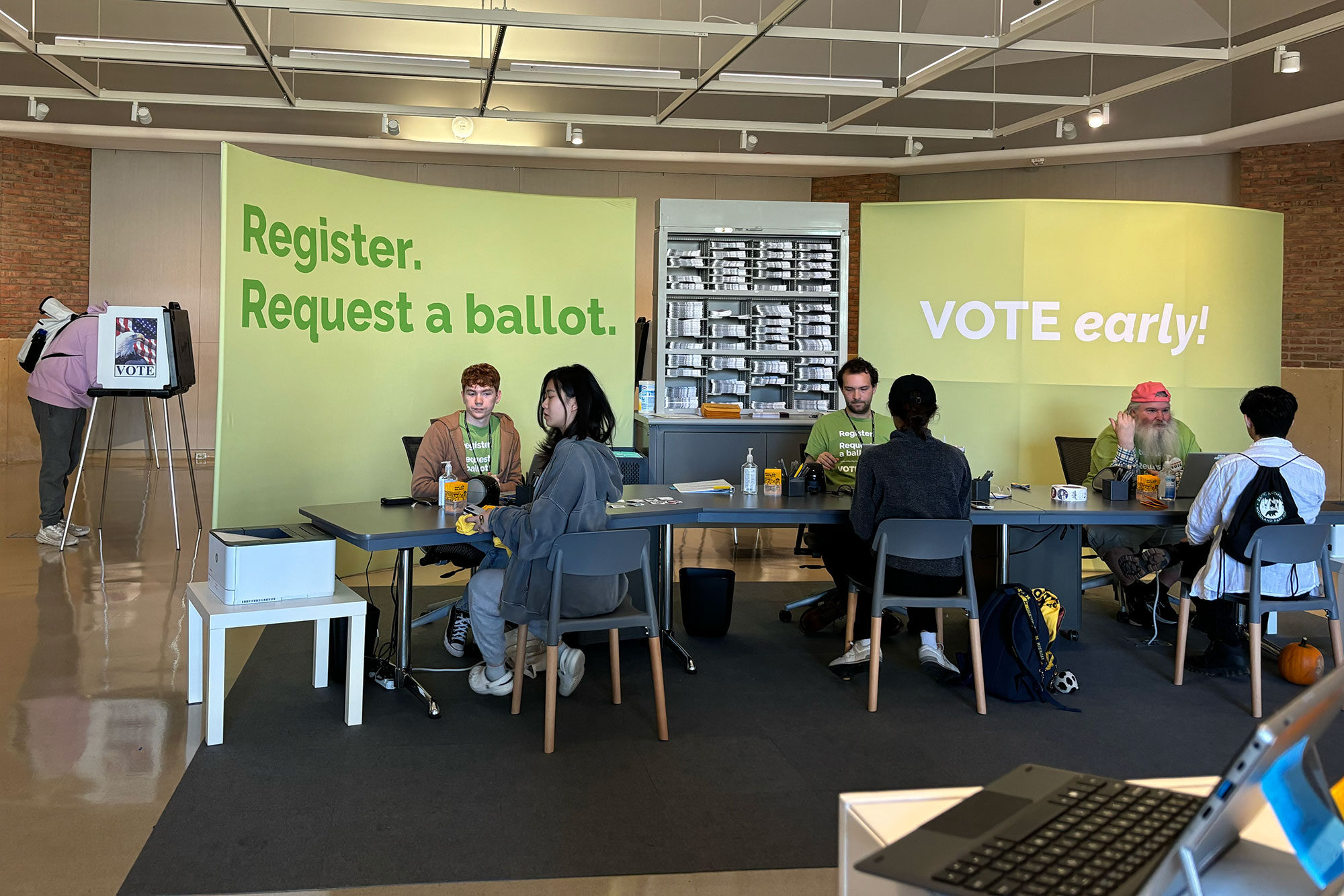 Staff members from the Ann Arbor City Clerk’s Office help people register to vote on Election Day at the Duderstadt Center’s Campus Voting Hub.