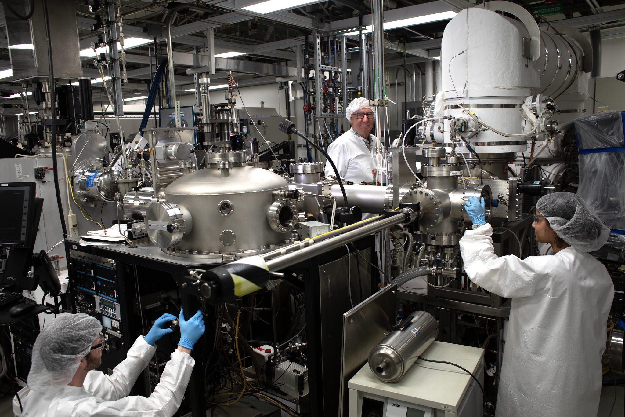 Steve Forrest poses for a portrait among chambers and technology that deposits thin films for organic light emitting devices in his lab of the Optoelectronic Components and Materials Group at the Electrical Engineering and Computer Science building.